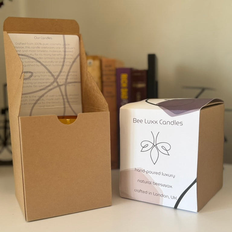 Bee Luxx Candles packaging on a surface with a blurred background