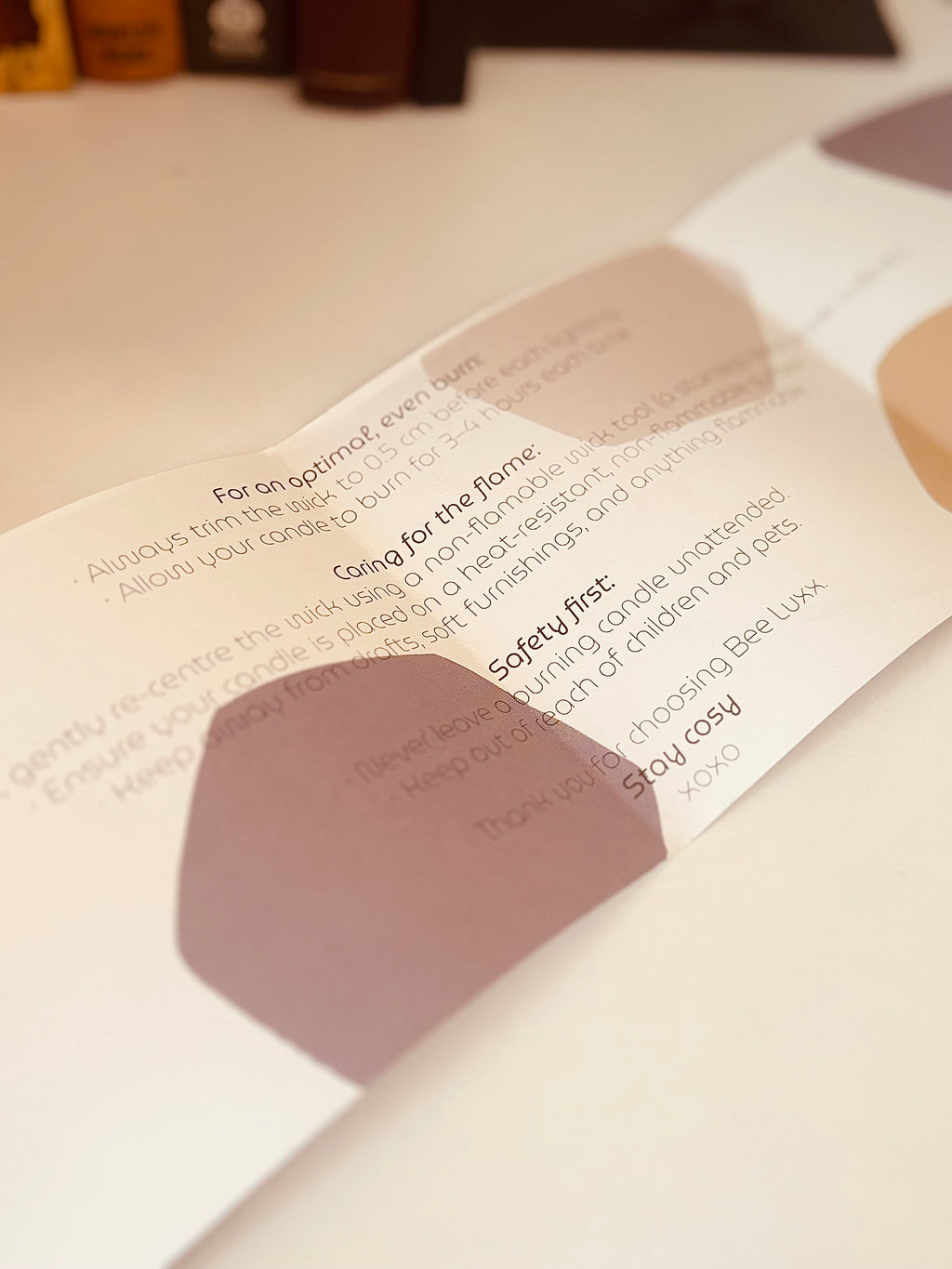 Close-up of a product packaging with text and two hexagonal shapes on a white surface.